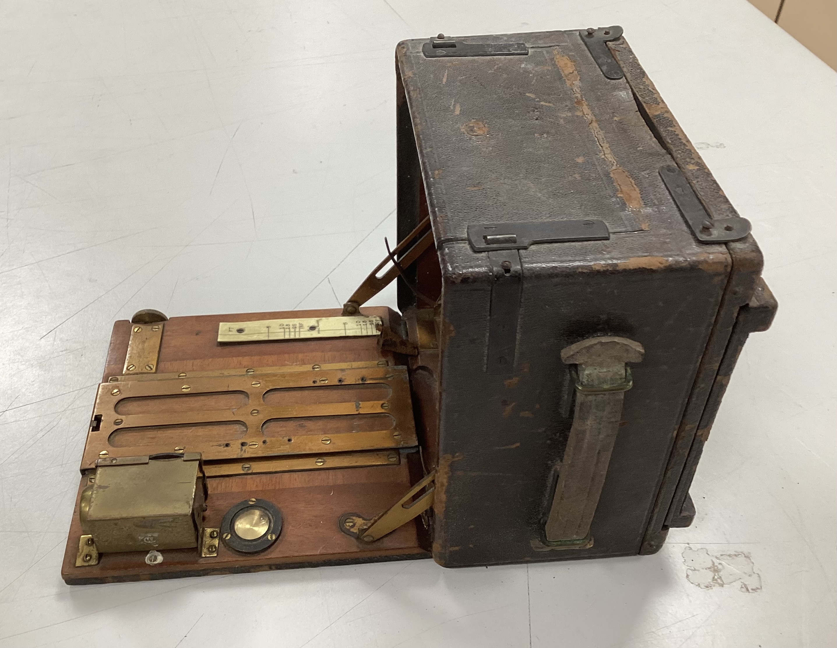 An Edwardian quarter plate camera, an early 20th century gilt decorated metal and Bakelite telephone, two Edwardian car lamps and a hand lamp etc.